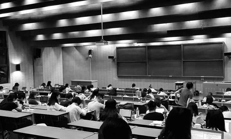 a university classroom with a lot of students sitting at desks
