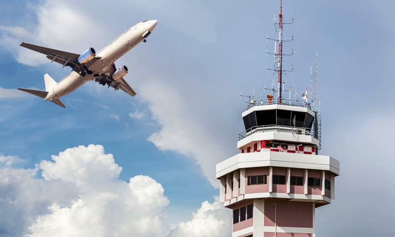Airliner passing by an airport control tower