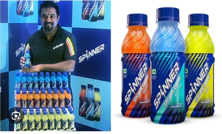 Muthaih Murlidharan holding a bottle of energy drink spinner