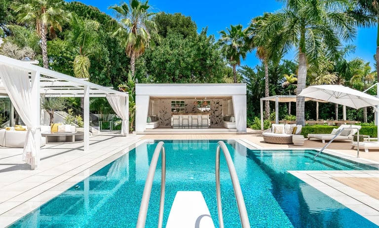 Poolside loungers and shaded pergola at Villa Serenity