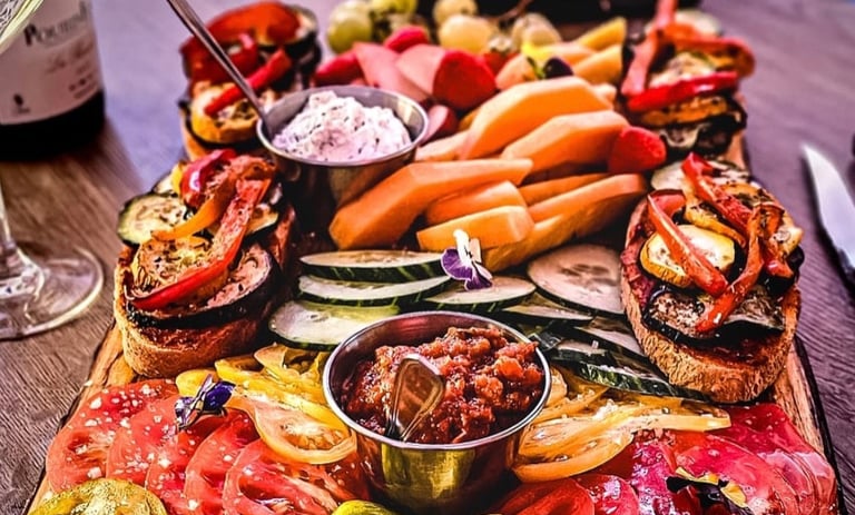 a platter of food and wine glasses