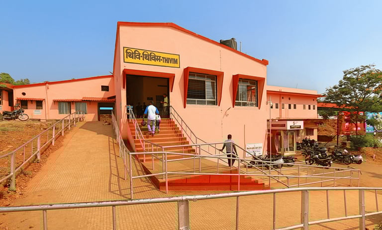 a man walking up at the stairs of a thivim railway station building