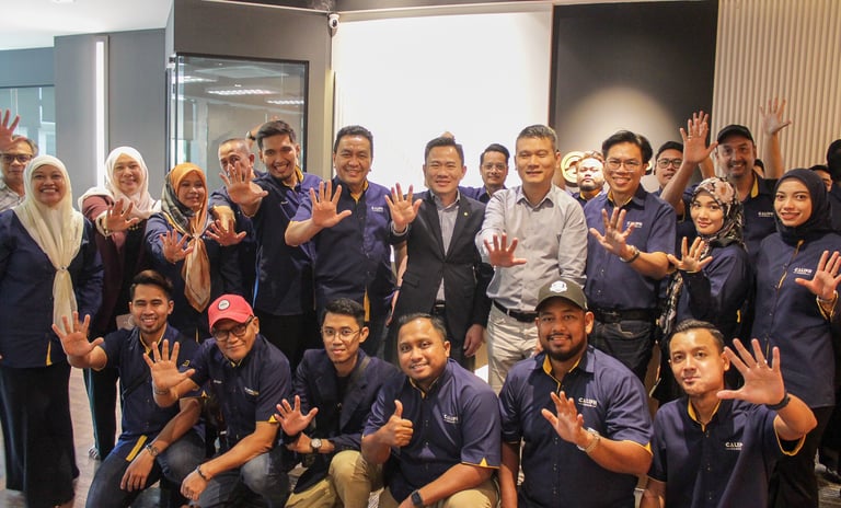 a group of people standing around a man in a blue shirt