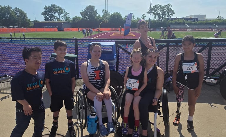 GLASA Team Athletes sitting and standing with a racing track in the background