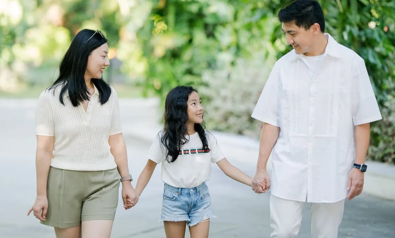 Family walking hand in hand along a resort pathway at InterContinental Bali Resort Bali