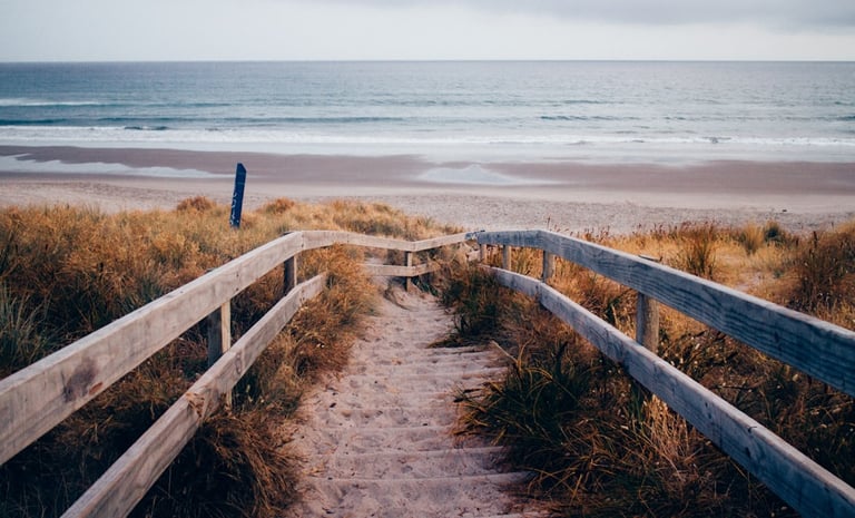 a wooden path leading to a beach