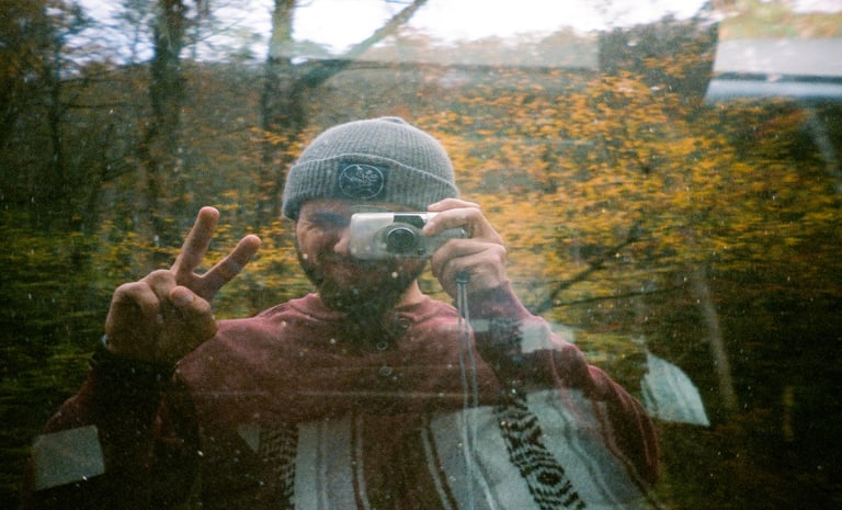 Car window selfie of Nate Bowery on film during fall in the Great Smoky Mountains.