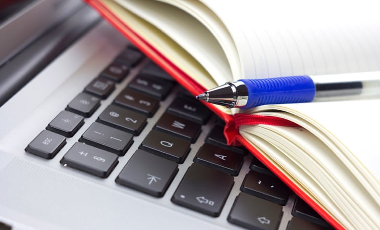 a pen and a pen on a laptop computer
