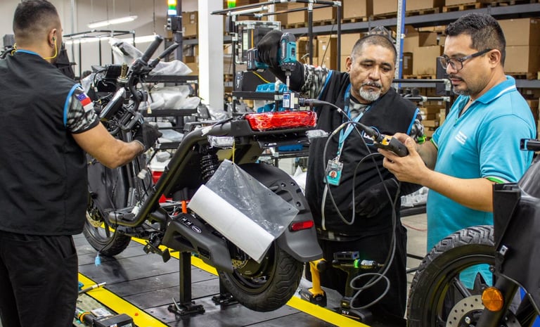 a man in a blue shirt is standing in a factory