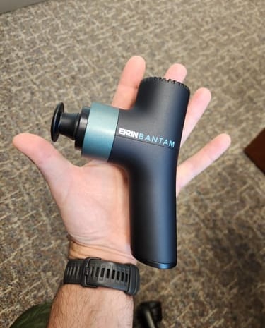 Ekrin Bantam lightweight portable massage gun, offering vibration therapy for gentle muscle relief