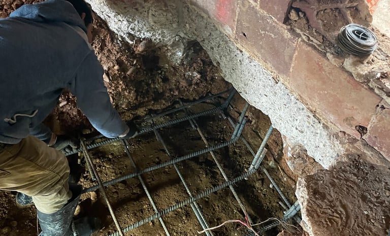 a man is working on a metal grate