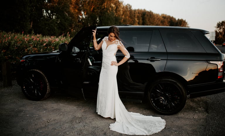 Elegant black luxury car with a bride, perfect for wedding transportation.