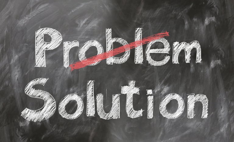 A blackboard with the word Problem crossed out and Solution written underneath