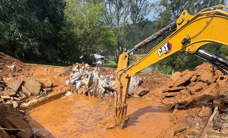 excavator digging out concrete pool