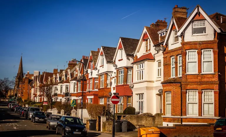 Row of traditional red brick Victorian terraced houses on a quiet suburban street in Streatham.