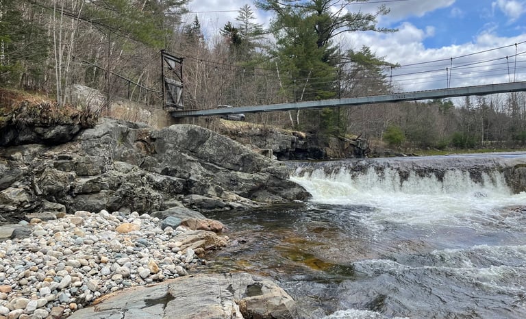 a bridge over a river with a dam