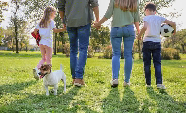 a family of three children playing soccer in a field