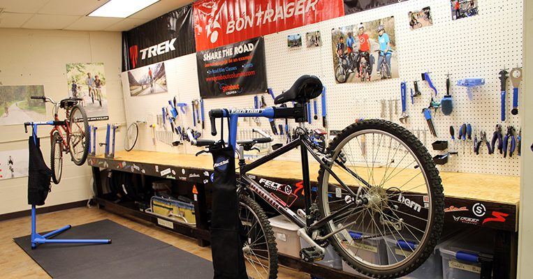 Photo of a bike on a bike mount like it is being worked on, with tools in the background