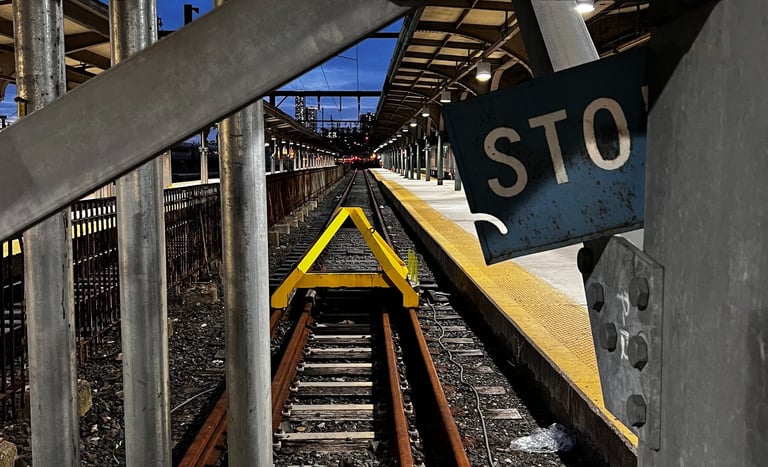 a stop sign on a railroad track