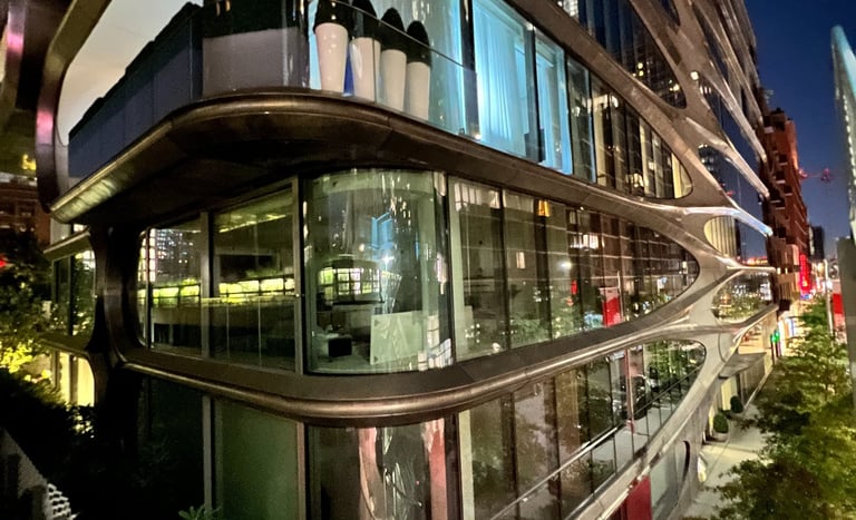 a building with a glass facade and a long glass balcony