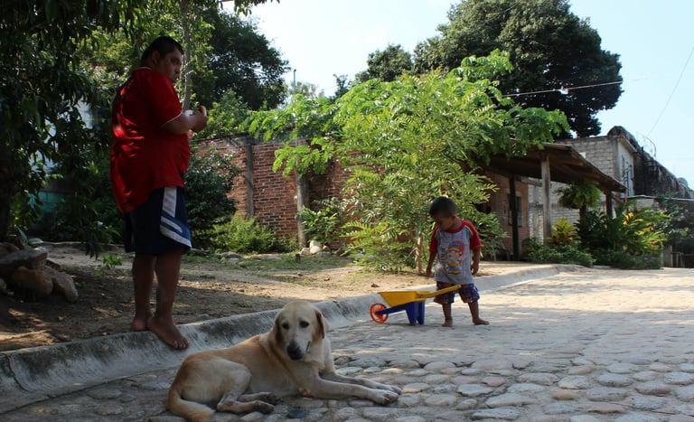 a man plays with his son in the streets of Puerto Vallarta