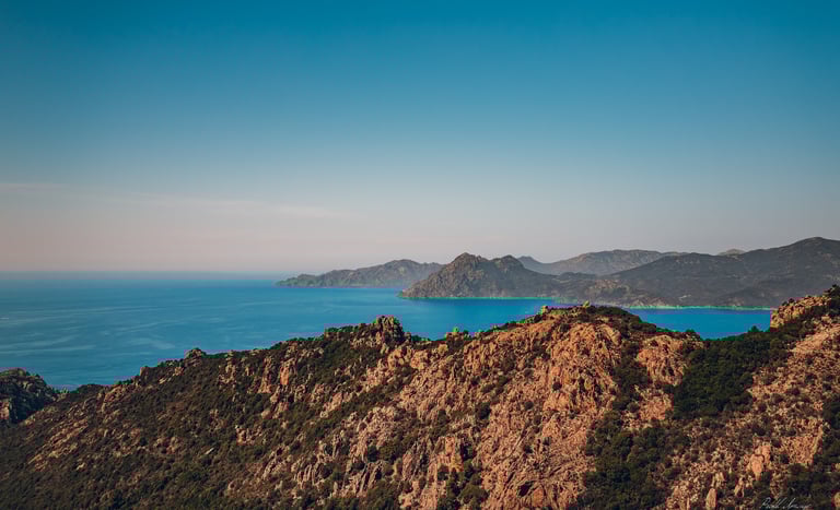 a mountain view of a mountain range with a blue sky