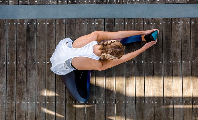Fashion photography - a woman in a white tank top and blue leggings