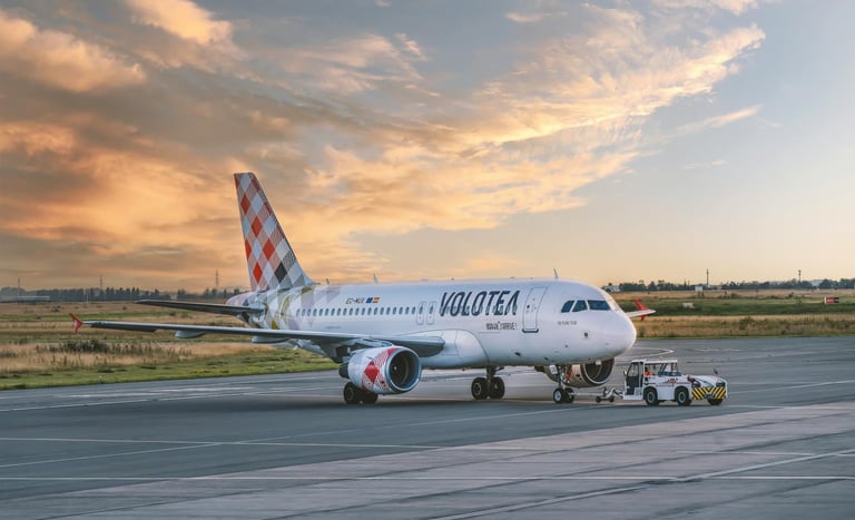 Volotea airplane on airport tarmac during sunset