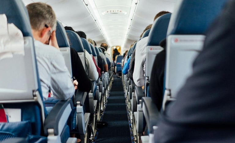 Interior of airplane with sitting people