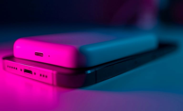 A power bank placed directly on top of a smartphone, and both devices are not in use