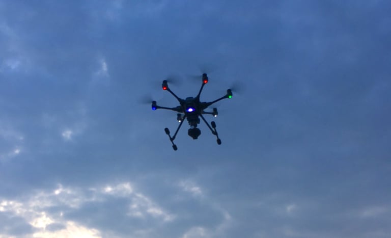 a small drone flying through the sky