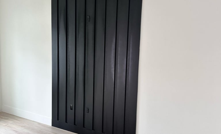 Interior door remodeling project featuring new white panel doors and black matte handles in resident