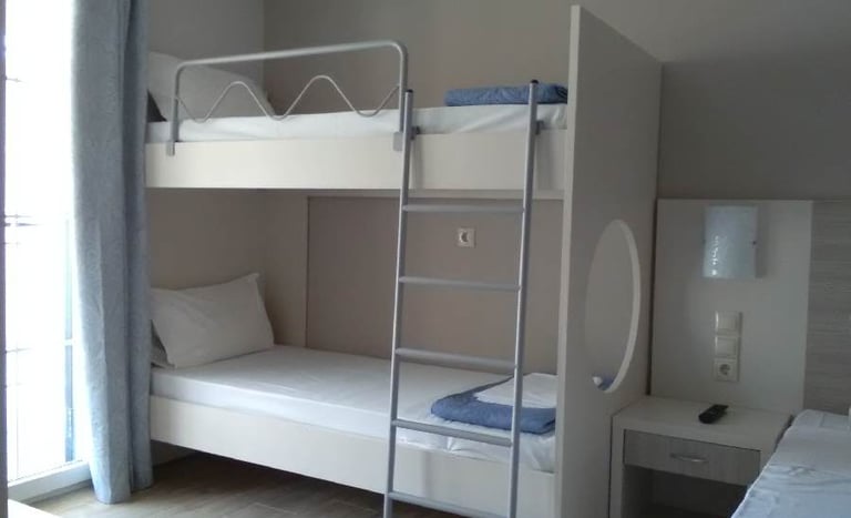 a bunk bed with a ladder and a bed