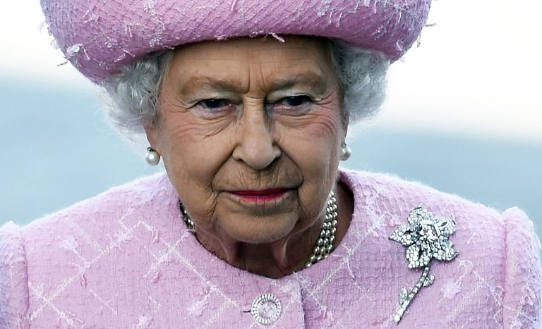 Queen Elizabeth II wearing the Cartier Williamson Pink Diamond Brooch.