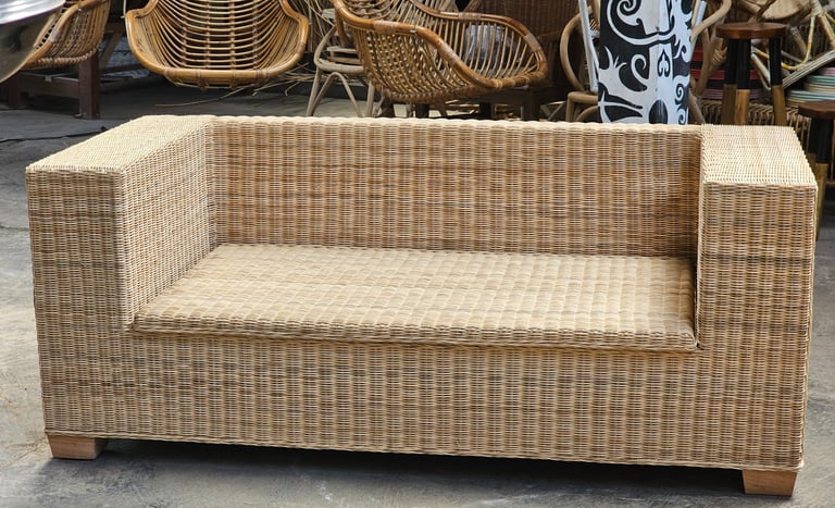 a wicker couch with wicker furniture