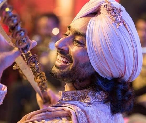 a man in a turban with a sword