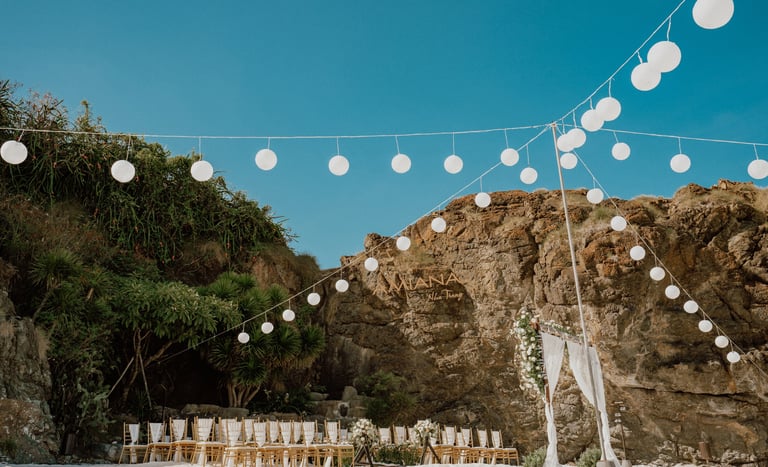 a wedding ceremony with white chairs and white chairs
