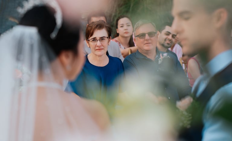 a bride and groomsmid are standing in front of a crowd