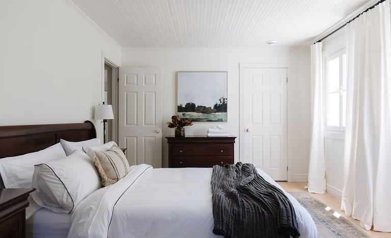 a bedroom with a bed and a dresser