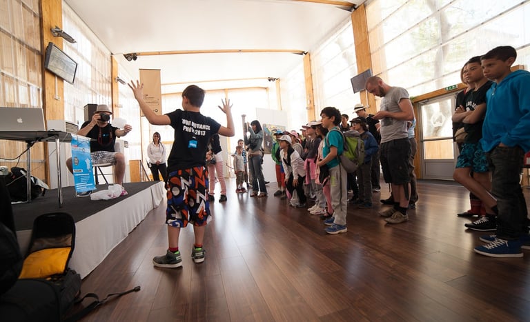 Pencil vs Camera : a group of people standing in a room with Ben Heine and Arthur