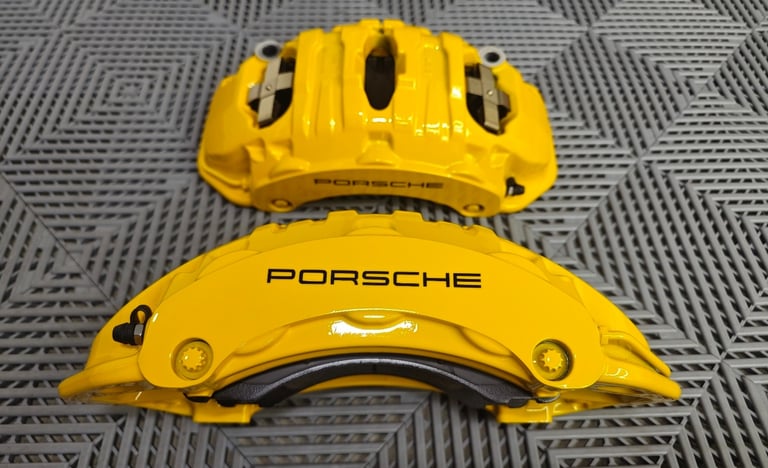 Porsche Macan GTS calipers with a color change from OEM Red paint to Signal Yellow powdercoat