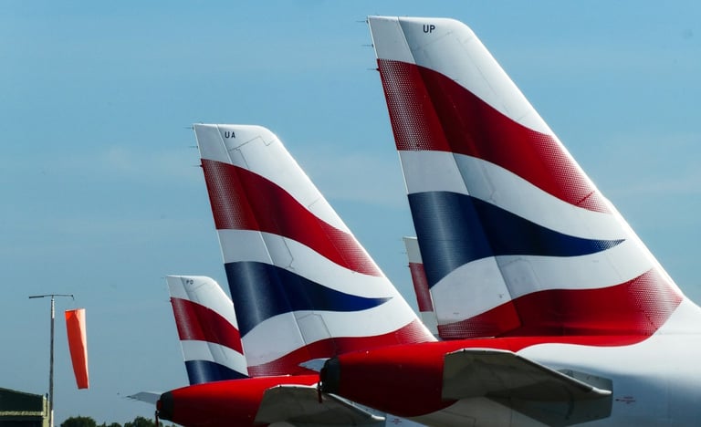 British Airways planes' tails visible in airport
