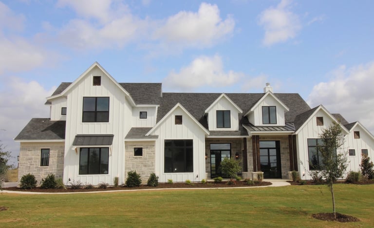 Large white modern farmhouse custom home exterior in DeKalb County, built by Built to Last