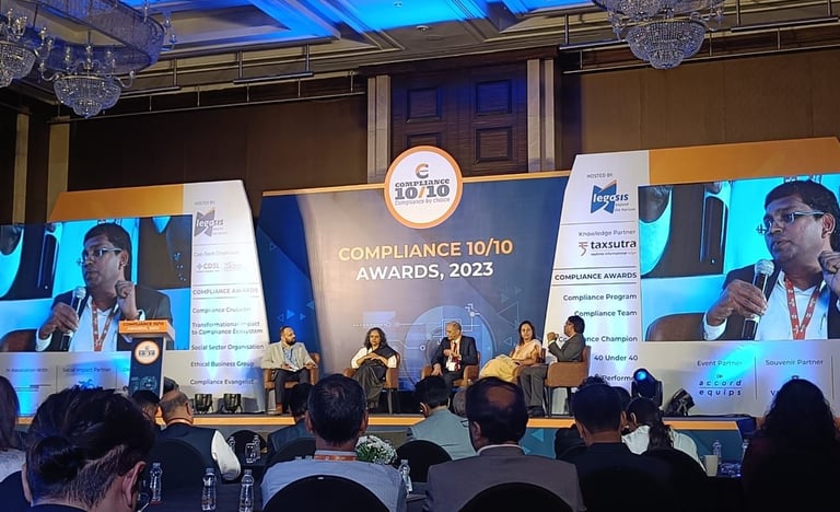 a group of people sitting at a podium with a speaker