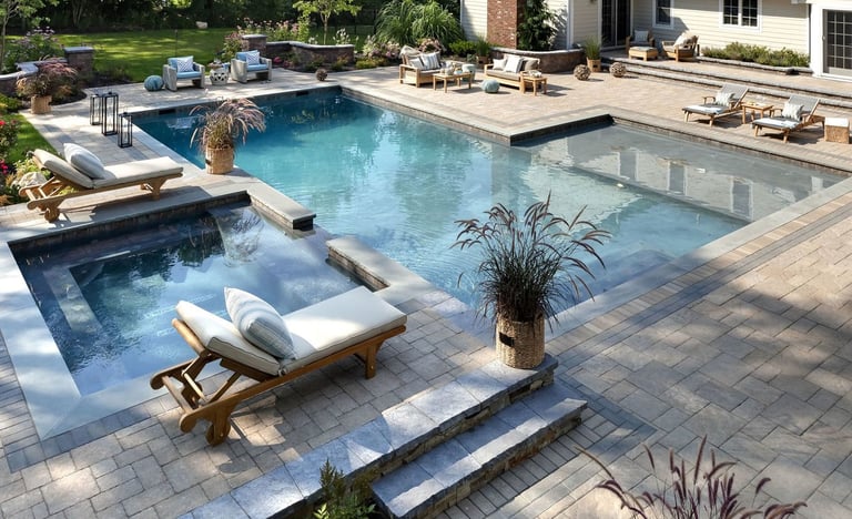 Custom Luxury Outdoor Pool and Patio with attached spa, custom masonry, and bespoke landscape design