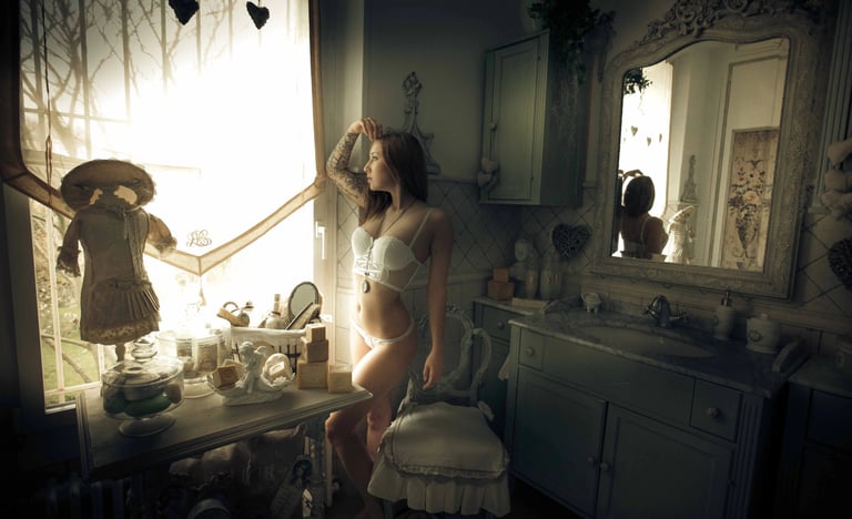 Henrick photo Boudoir A woman in white underwear standing in front of a bathroom window