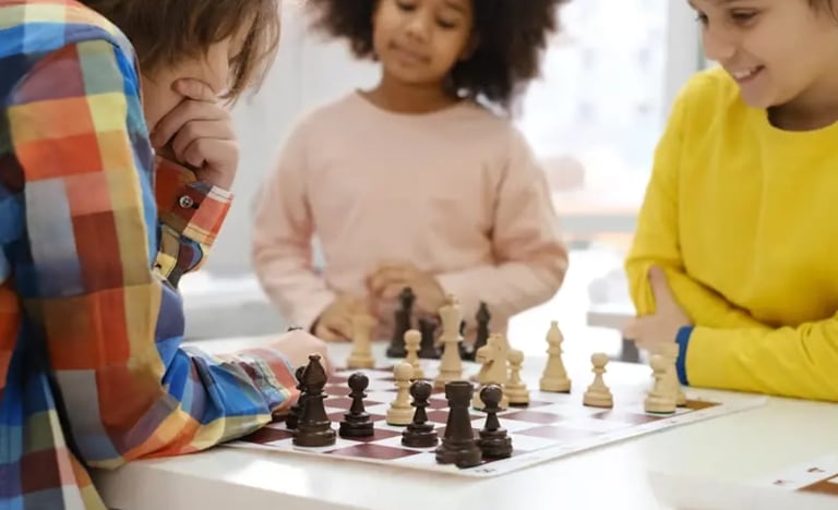 a group of children playing chess in a room