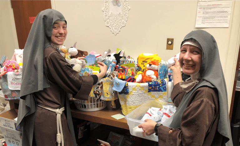 Sisters assembling new baby welcome baskets