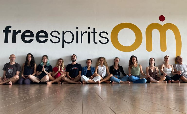 a group of yogis sitting on a wooden floor