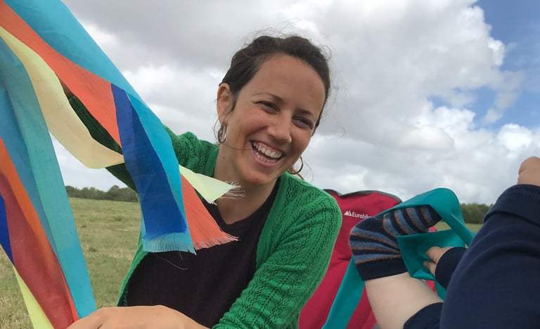 a woman sitting in a hammock with a baby